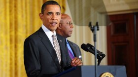 President Obama, teleprompter to his side, spoke at the White House on Aug. 11 to mark his signing of the Manufacturing Enhancement Act. U.S. Trade Representative Ron Kirk is behind him.