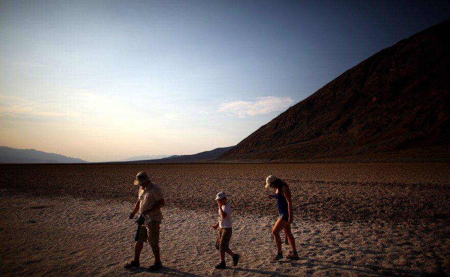 Tourists walk across the Badwater Basin which sits 282 feet below sea level, in Death Valley, Calif., on June 30. People from around the world flock to the area to experience temperatures that rise to the high 120's on a regular basis.