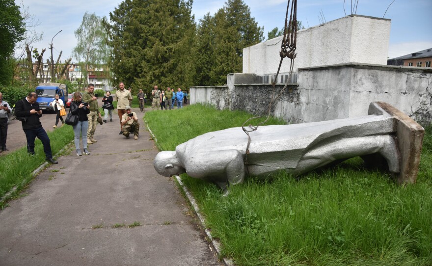 A statue of a Soviet soldier lies facedown in Chervonohrad, in western Ukraine. The monument from the city's Eternal Flame memorial complex is among those that were dismantled following Russia's invasion of Ukraine.