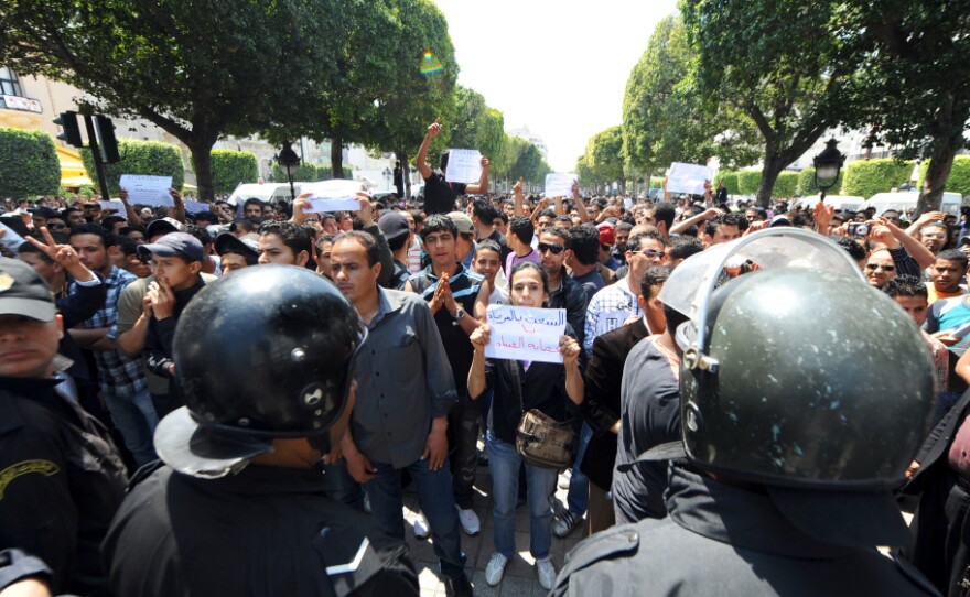 Tunisian riot police face protestors in the center of Tunis on May 6 during a demonstration organized by youths denouncing the transitional government and calling for "a new revolution."