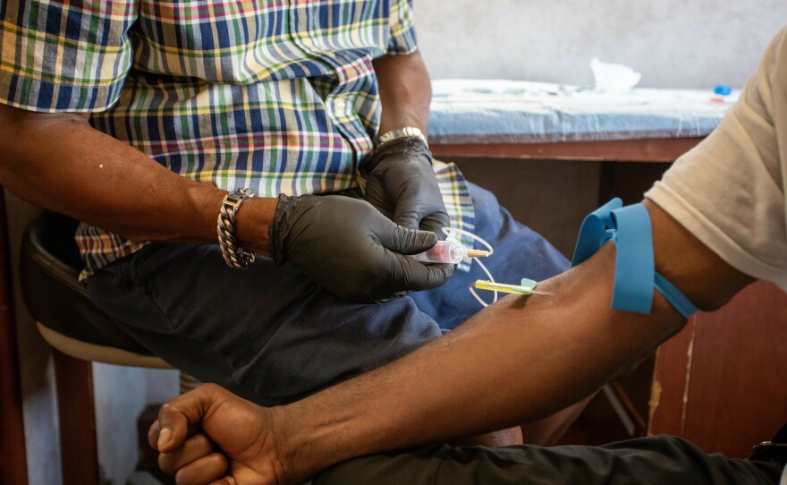 Kenneth Pierson conducts a blood test in the van. The SPOT vans are staffed with nurse practitioners who can draw blood, conduct tests, prescribe medication and provide some primary care.