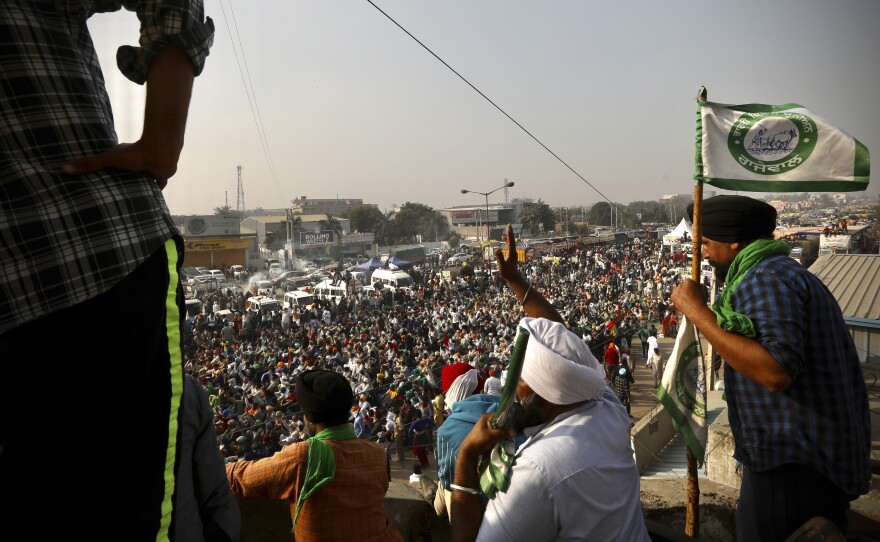 Farmers raise slogans during a protest Thursday on a highway at the Delhi-Haryana state border, India. Tens and thousands of farmers have descended upon the borders of New Delhi to protest new farming laws that they say will open them to corporate exploitation.