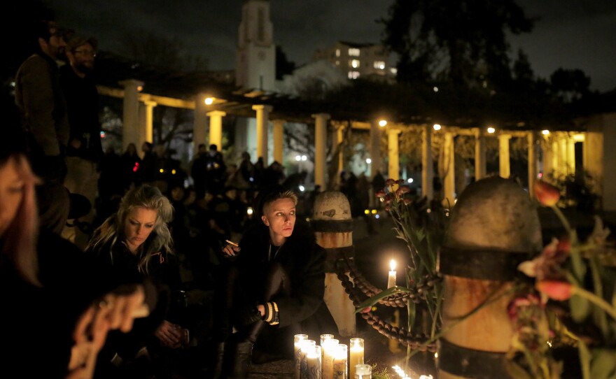 People gather on Monday at Lake Merritt in Oakland, Calif., for a vigil honoring the victims of the Friday night fire at the Ghost Ship warehouse, where 36 people were killed.