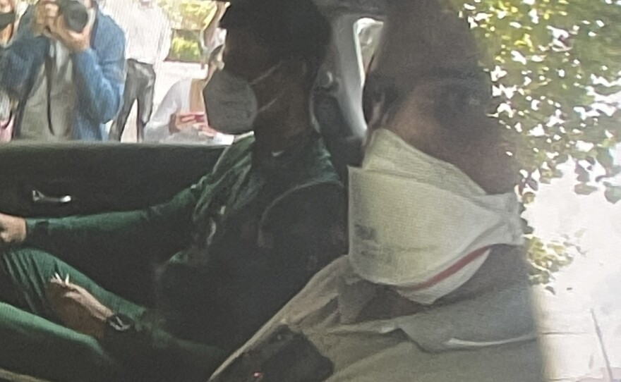 Novak Djokovic sits in the back of car arriving at an immigration detention hotel in Melbourne, Australia Saturday, Jan. 15, 2022.