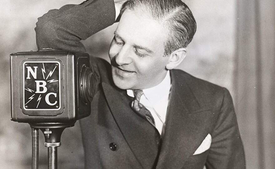 Young Winchell playfully leans against an NBC microphone. (undated photo)