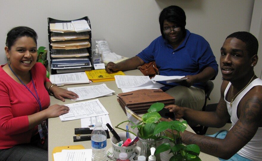 Sandra Rodriguez, a healthcare navigator for the city of Houston, helps Pamela Thompson and her son Charles Slater evaluate their insurance options on Monday.