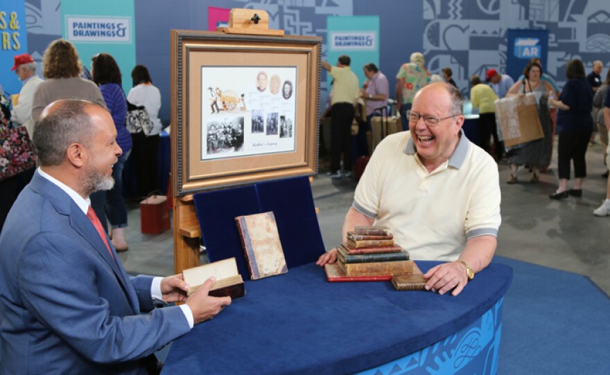 John Schulman (left) appraises a mid-19th century Mormon book archive in Omaha, Neb.