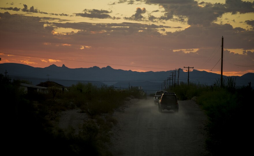 Trucks and SUVs leave a camp outside Ajo, Arizona, on Aug. 26, 2017, for a drive to Organ Pipe Cactus National Monument along the U.S.-Mexico border where the occupants will search on foot for missing migrants.