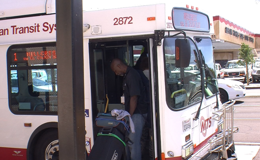 James Smith, camera equipment in tow, boards a San Diego city bus April 6, 2015 to get to his television and film class at San Diego City College.
