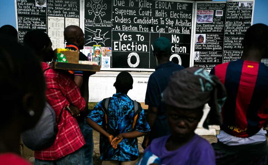 The Daily Talk uses chalk, photos and Liberian slang to spread the latest news. Editor Alfred Sirleaf set up the blackboard on Monrovia's main thoroughfare.