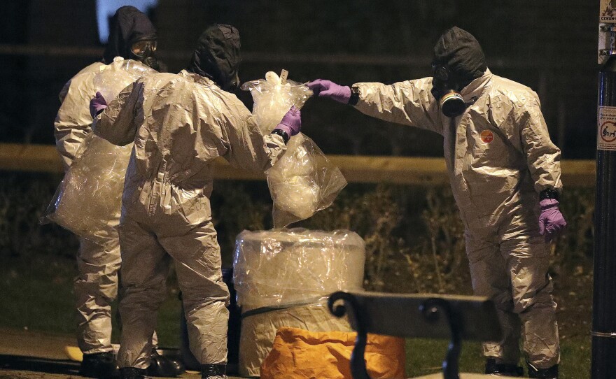 Investigators in protective suits work at the scene in the Maltings shopping center in Salisbury, England, on Tuesday.