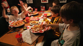 When they eat out at a restaurant, kids consume more calories than they do at home. Here, members of the Long Island Gulls hockey team enjoy a lunch at TGI Friday's back in 2007 in Marlborough, Mass.