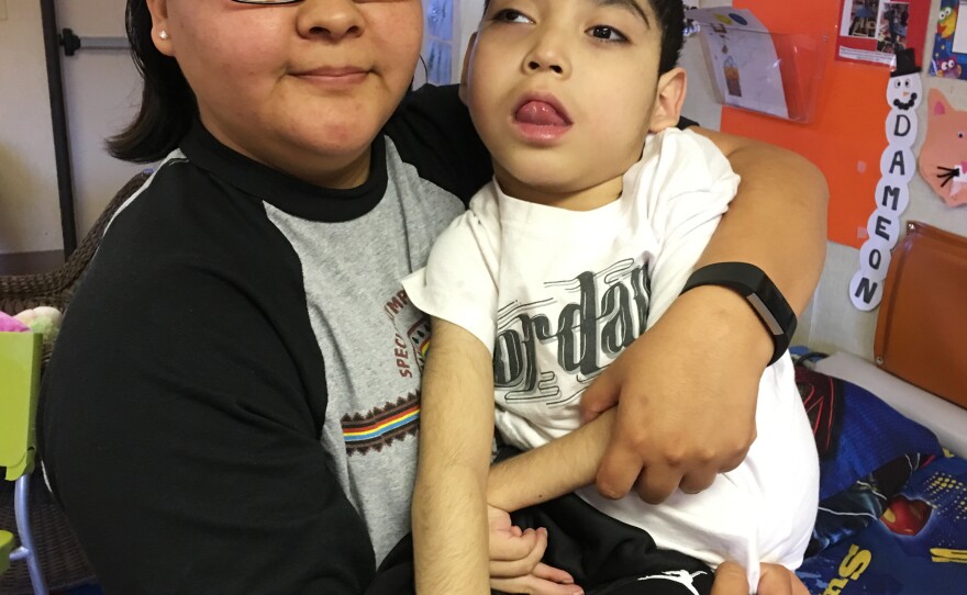 Felencia Woodie holds her son Dameon David, 8. He is one of seven medically fragile children who attend Saint Michael's Association for Special Education.