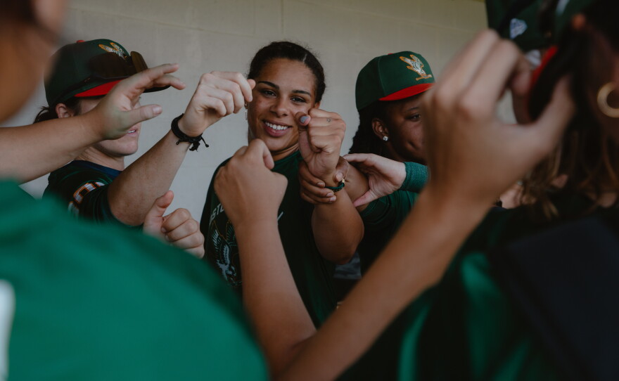 Robinson (center) fist bumps her teammates at the conclusion of a preseason scrimmage prior to the WPBL's opening weekend on Thursday, July 30, in Springfield, Ill.