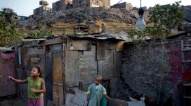 Children play near their home in the Duweika area of Cairo. A growing majority of Egypt's population is scraping by on less than $100 a month and can only afford to live in shantytowns and tents.