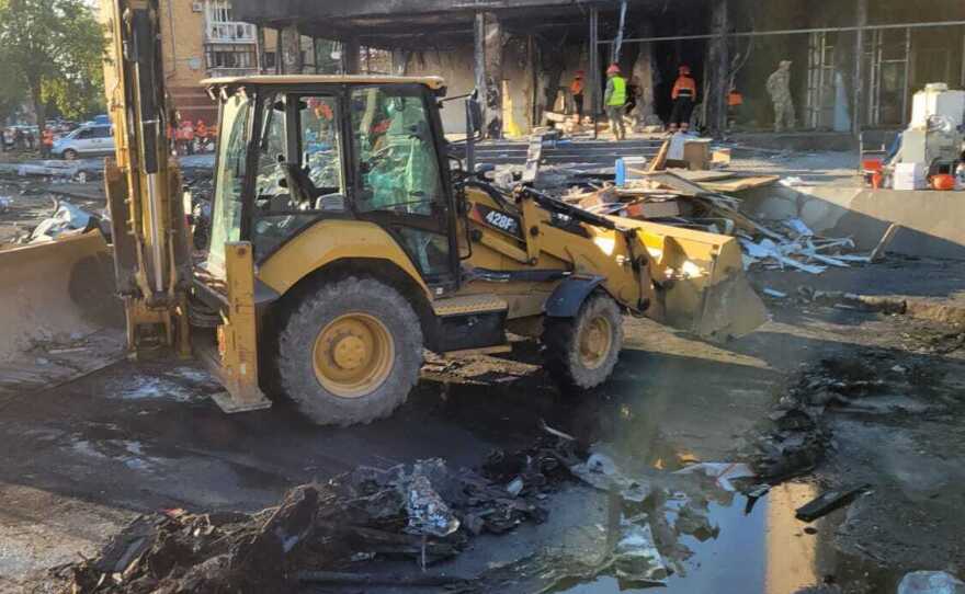 Clean-up crews work with shovels and picks as well as heavy equipment after missile strikes heavily damaged buildings in a civilian area of downtown Vinnytsia.