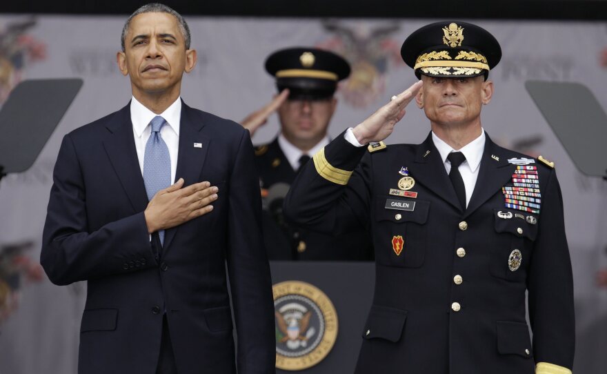 President Obama and superintendent of the Military Academy, Lt. Gen. Robert L. Caslen Jr., take the Pledge of Allegiance at the West Point graduation ceremony on Wednesday. In an interview with NPR, President Obama said U.S. foreign policy should focus more on diplomatic efforts than large-scale military operations.