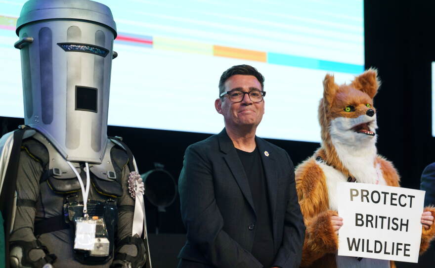 Labour's Andy Burnham stands with Count Binface and a Protect British Wildlife candidate after winning the Makerfield by-election, boosting his bid to become the UK's next prime minister, June 19, 2026.