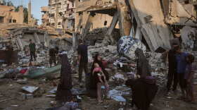 Palestinians salvage their belongings from the rubble of a building and tents destroyed in an Israeli airstrike in Gaza City, Thursday, July 30, 2026.