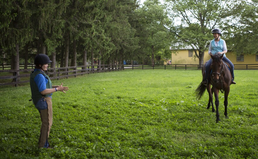 NPR's Laurel Dalrymple rides for the first time the former racehorse she will go on to adopt, as Beverly Strauss coaches.