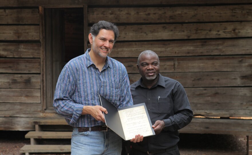 Joseph McGill gives HISTORY DETECTIVES host Eduardo Pagán a tour of the Hewn-Timber Cabins at Francis Marion University to give insight into what life as a slave might have been like for Willoby, the woman named in this bill of sale.