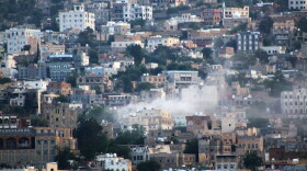 FILE - Smoke rises after an attack by Houthi rebels on the city of Taiz, Yemen, on Oct. 21, 2015. (AP Photo/Abdulnasser Alseddik, File)