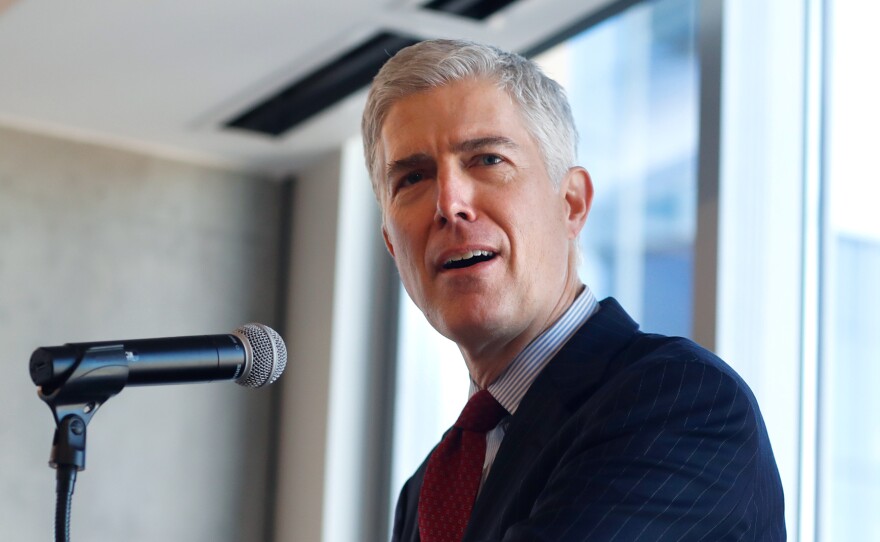 Judge Neil Gorsuch of the 10th U.S. Circuit Court of Appeals   makes a point while delivering prepared remarks before a group of attorneys last Friday at a luncheon in a legal firm in lower downtown Denver.