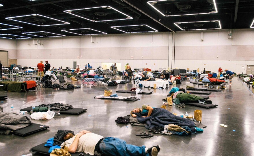 People rest at the Oregon Convention Center in Portland, Ore., in June 2021 during a record-breaking heat wave that killed hundreds of people in the Pacific Northwest. Temperatures soared above 110 degrees.