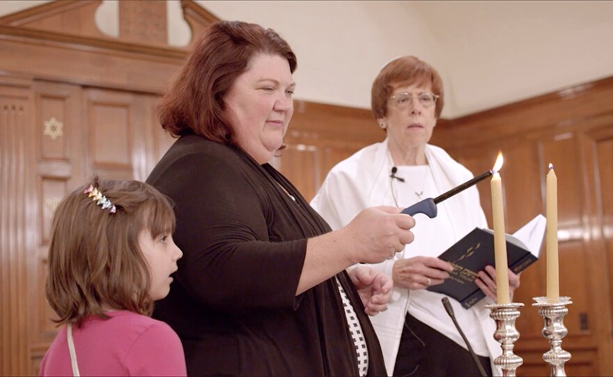 In Dothan, Ala., Karen, Emily and a Rabbi light candles.