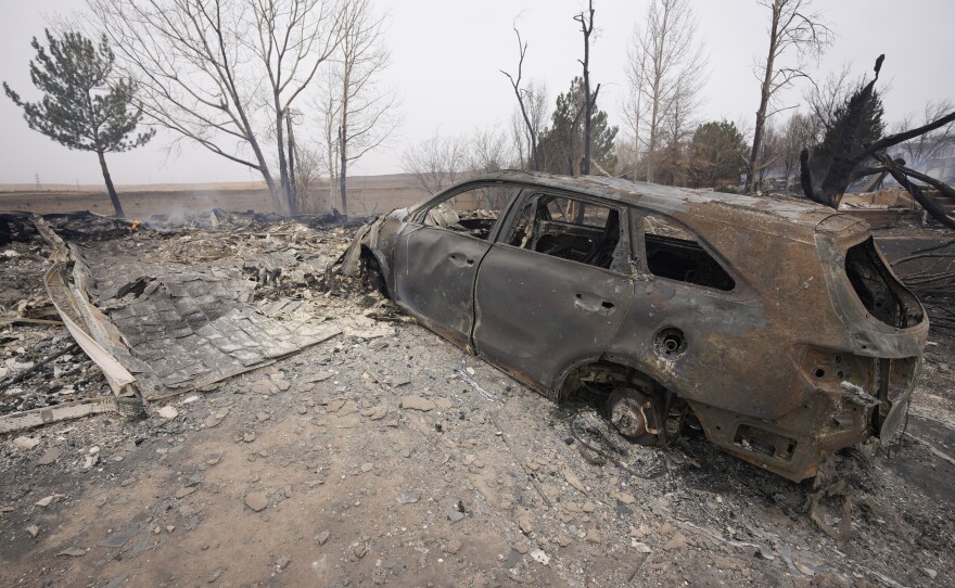 Damage to homes burned by wildfires after they ripped through a development are shown Friday in Superior, Colo.