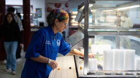 Great Valley School District culinary coordinator Jenifer Halin cleans up the salad bar in the cafeteria at Great Valley High School in Malvern, Pennsylvania.
