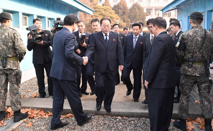 With North Korea planning to participate in the 2018 Winter Olympics, delegation head Jon Jong Su, vice chairman of the Committee for the Peaceful Reunification of the Country, crosses the concrete border to attend a meeting at the truce village of Panmunjom in the demilitarized zone separating the two Koreas.