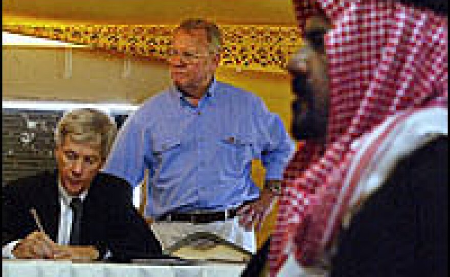 Ryan Crocker (left) and retired U.S. Gen. Jay Garner (center) gather to discuss post-war Iraq at the Tallil air base in April 2003.