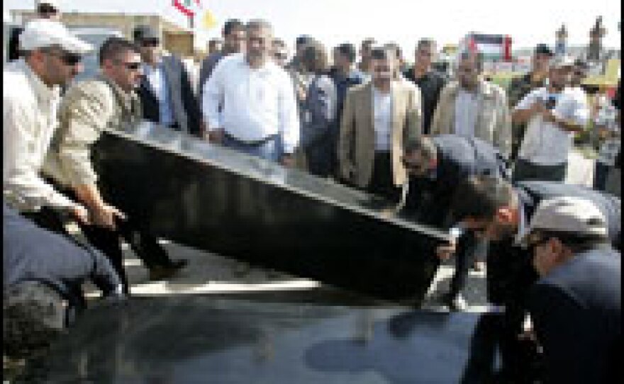 Hezbollah members hand over the bodies of two Israeli soldiers to the Red Cross. The soldiers, who were captured by militants in July 2006, were exchanged for Lebanese prisoners held by Israel on Wednesday at the Rosh Hanikra border crossing.