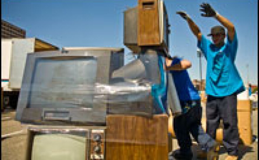 Workers stack used electronics, many of them made in China, at a recycling drive in Brooklyn, New York.
