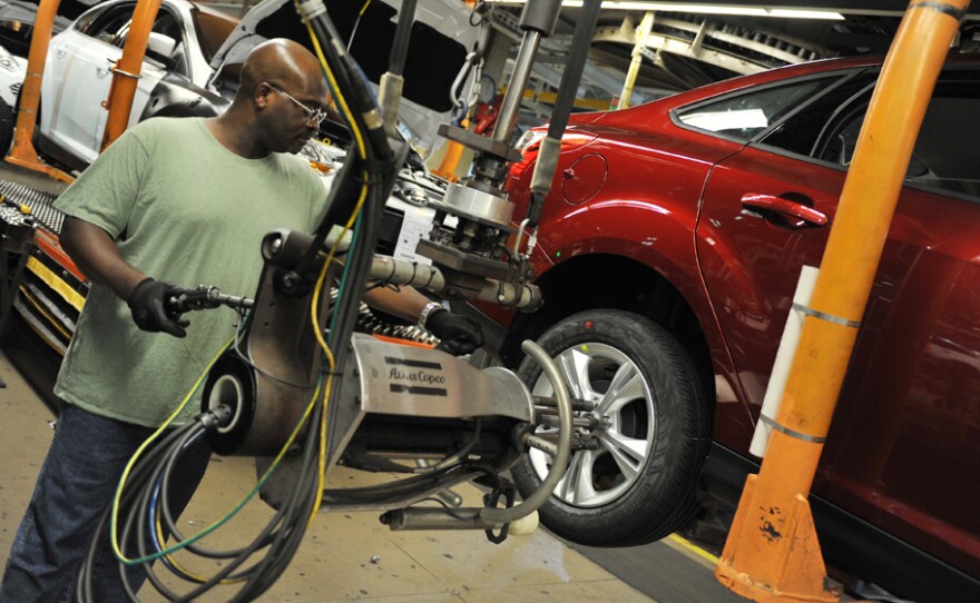 An auto worker tightens bolts on a Focus at a Ford plant in Michigan in October. Labor unions predicted in 1993 that NAFTA would send many U.S. manufacturing jobs to Mexico, and they continue to argue that the pact prompted a race to the bottom for workers.