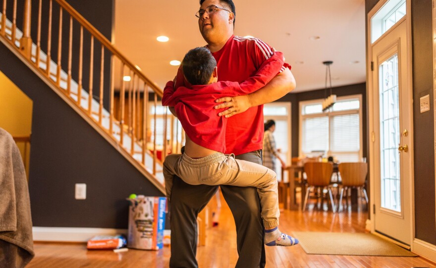 Hansel Pham lifts Henry at home on April 5, 2019.