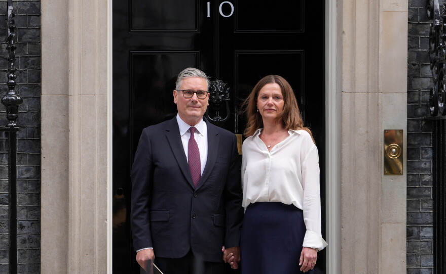 Britain's Prime Minister Keir Starmer and wife Victoria stand in front of 10 Downing Street door after speaking to the media in London, Monday, June 22, 2026.