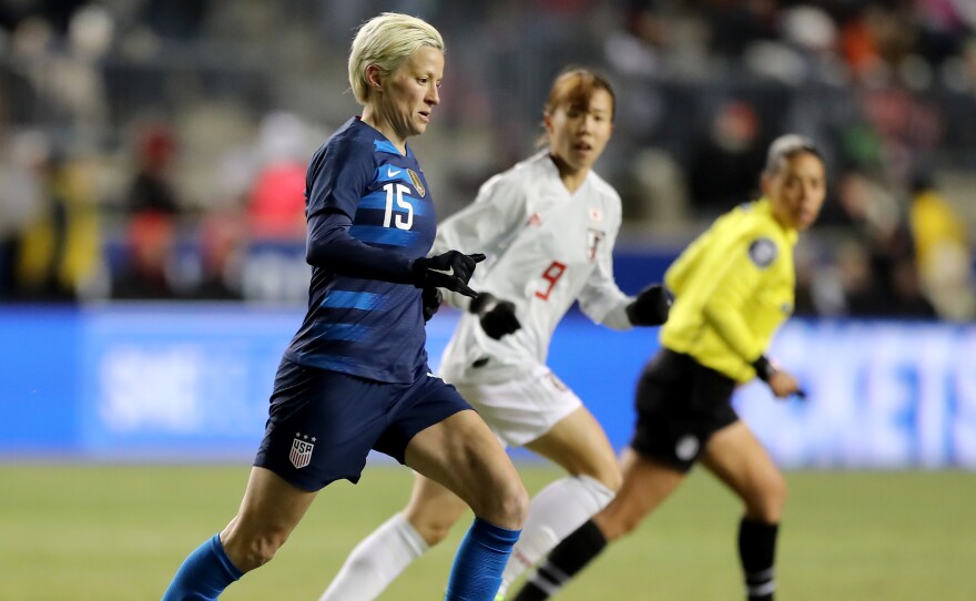 U.S. forward Megan Rapinoe takes the ball as Japan's Hina Sugita stays close on the first day of the SheBelieves Cup in Chester, Penn., on Wednesday night.