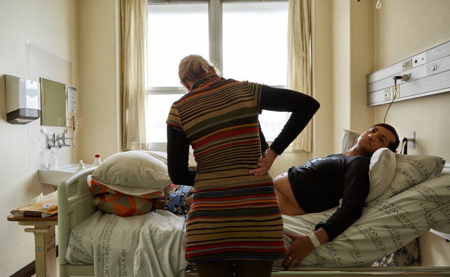 The day before Chedino's surgery, Dr. Gertrude van Niekerk (center) and Dr. Kevin Adams drop by for a last check up and to discuss the position and outline of Chedino's breasts at the Groote Schuur Hospital in Cape Town, South Africa, in 2017.