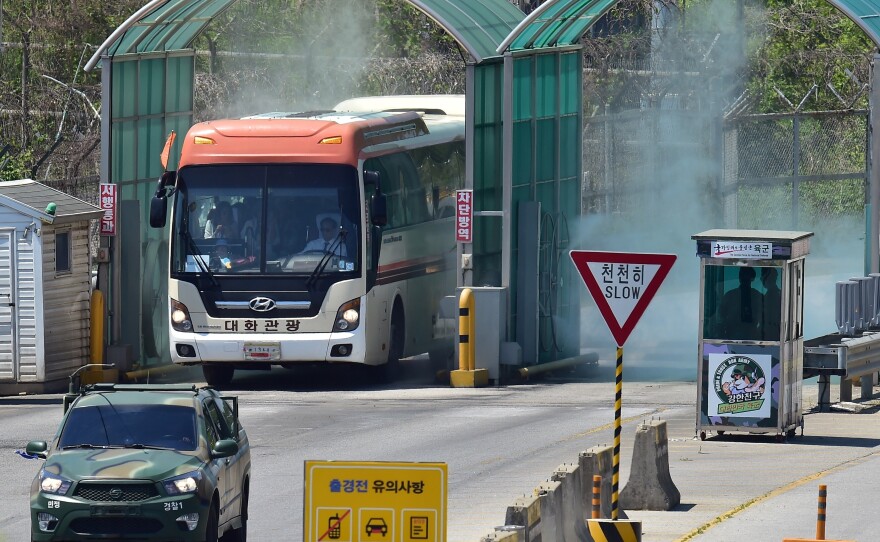 A bus carrying a group of 30 peace activists drives past a military checkpoint after crossed the border through the demilitarized zone (DMZ) separating the two Koreas.