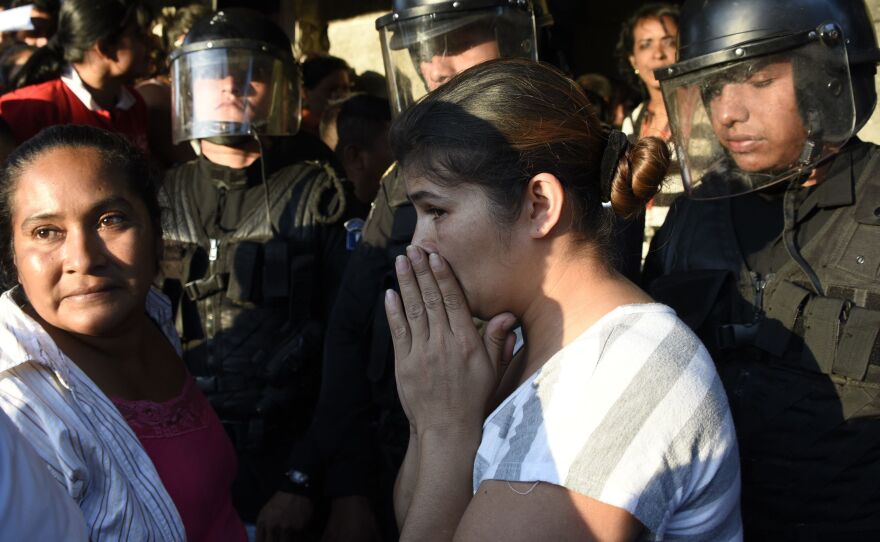 Relatives gather outside the Virgin of the Assumption Safe House near Guatemala City, Guatemala. Dozens of girls died after a fire broke out at the youth shelter on Wednesday.