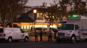 Investigators collect evidence at Salon Meritage hair salon where a man shot nine people, killing eight of them, on October 12, 2011 in Seal Beach, California. 