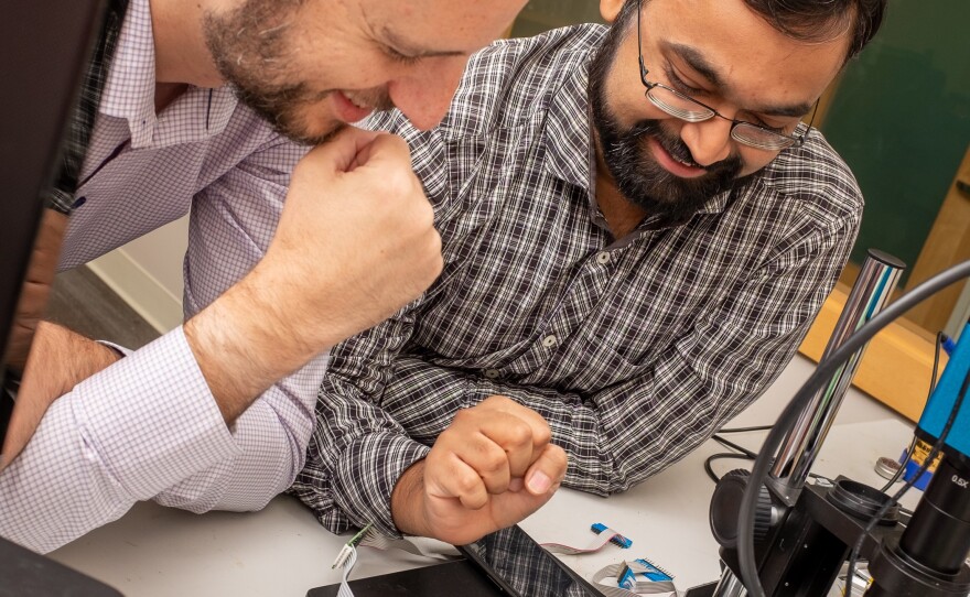 UCSD engineers Nishant Bhaskar and Aaron Schulman look at skimmers taken from gas stations on Friday, August 9, 2019.