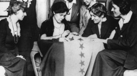 Celebrating ratification of the women's suffrage amendment, Alice Paul, seated second from left, sews the 36th star on a banner, in August of 1920. The banner flew in front of headquarters of the Women's Party in Washington of which Miss Paul was national chairperson. The 36th star represented Tennessee, whose ratification completed the number of states needed to put the amendment in the Constitution.
