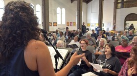 CEO Steph Johnson leading Voices of Our City choir in an original song in St. Paul's Episcopal Cathedral.