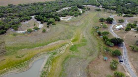 A top-down aerial view of Lake Corpus Christi reveals dry lakebed and shrinking water levels as drought continues to strain the region's supply on April 10, 2026. 
