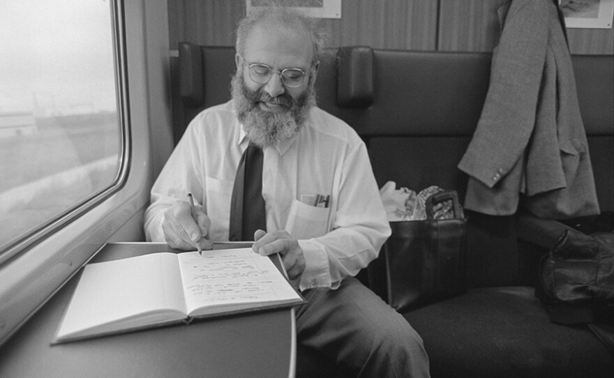 Oliver on train, writing in journal, 1987.