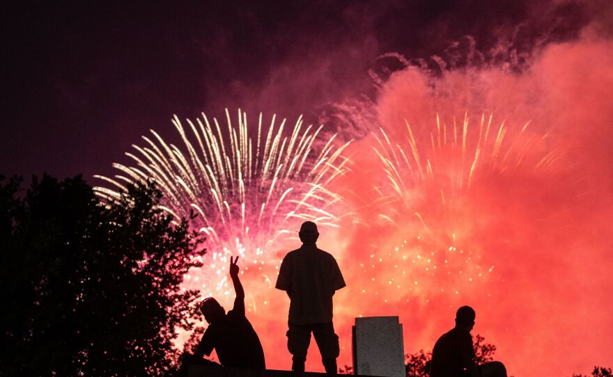 Fireworks are a staple of the Fourth of July and other holidays, but they can frighten animals and pets. Here, spectators at the World War II Memorial watch Independence Day fireworks in Washington, D.C., in 2020.