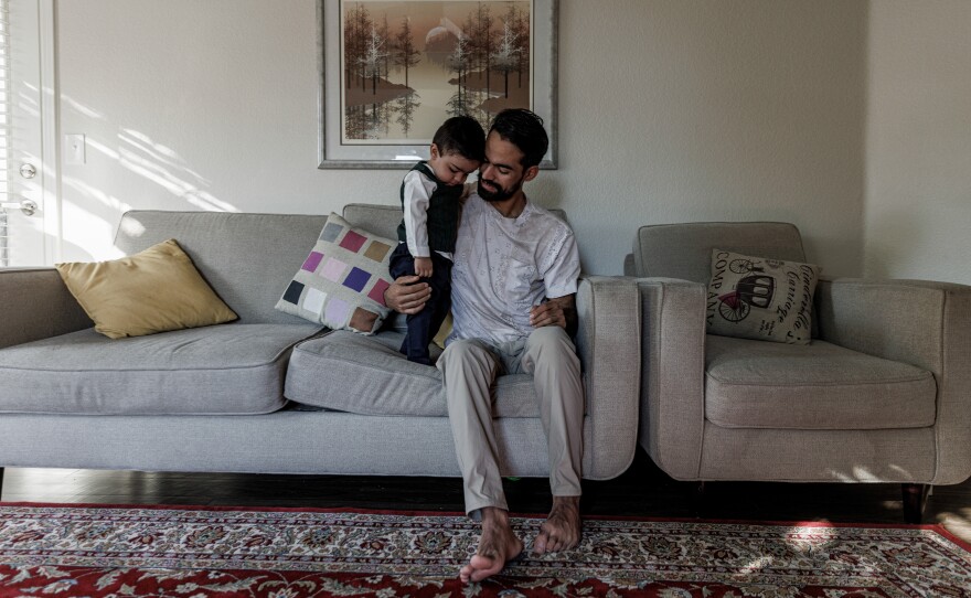 Afghan helicopter pilot Rashid Ahmad Muslim, 25, with his 14-month-old son, Mohammad, in their home in Chandler, Ariz. Mohammad was born on a U.S. military base in Germany.